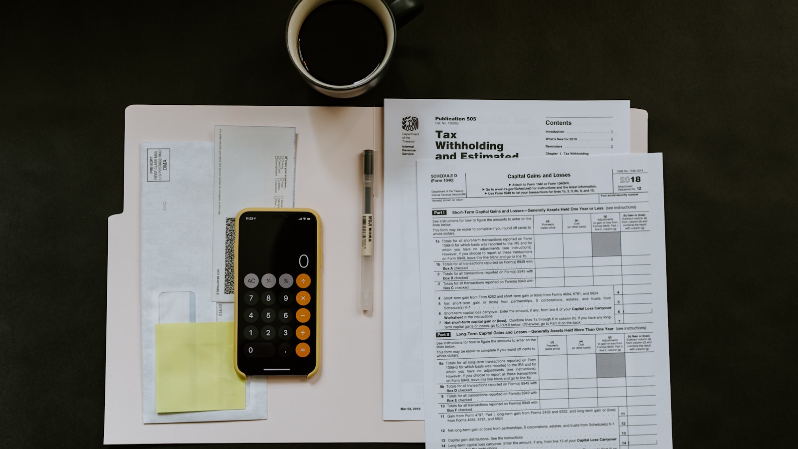 Tax forms, calculator and paperwork on an accountant's desk